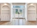 Bright entryway with hardwood floors, built-in shelves, and elegant doors at 2509 N Dundee St, Tampa, FL 33629