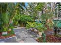 Lush courtyard with paved patio and seating area surrounded by tropical plants and trees, perfect for relaxing outdoors at 4950 Bayshore Blvd # 13C, Tampa, FL 33611