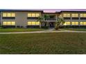 Condo building at dusk, showing the well-lit entrance and landscaping at 4600 Marine Parkway # 104, New Port Richey, FL 34652