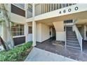 Condo building entrance with stairs and landscaping at 4600 Marine Parkway # 104, New Port Richey, FL 34652