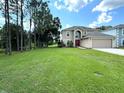 Two-story house with a large backyard, providing ample outdoor space at 5239 Tummel Ct, Wesley Chapel, FL 33545