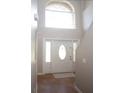 Bright entryway with tile flooring, a large window, and a white door at 5239 Tummel Ct, Wesley Chapel, FL 33545