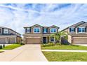 Two-story house with a two-car garage and landscaped front yard at 11321 Alachua Creek Ln, Riverview, FL 33579
