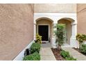 Private entrance with landscaping and walkway at 26607 Chimney Spire Ln, Wesley Chapel, FL 33544