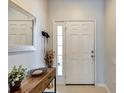 Bright entryway with mirror, console table and decor at 26607 Chimney Spire Ln, Wesley Chapel, FL 33544