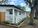 Charming white cottage with a front porch and well-manicured landscaping at 2300 23Rd S St, St Petersburg, FL 33712