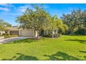 Single-story house with a two-car garage and well-maintained lawn at 9343 Rolling Circle, San Antonio, FL 33576