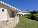 Charming home featuring well-manicured lawn, front entrance and beautiful Florida landscaping at 1745 Harbor W Cir, Largo, FL 33770