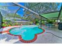 Inviting screened pool area with brick coping and patio furniture at 2011 Green Juniper Ln, Brandon, FL 33511
