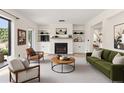 Bright living room with a fireplace, modern furniture, and built-in shelves for stylish storage and decor at 5313 Bayshore Blvd # 5313, Tampa, FL 33611