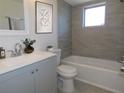 Updated bathroom with gray tile, white tub, and gray vanity at 6026 22Nd N Ave # 5, St Petersburg, FL 33710