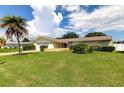 Ranch style home with a large yard, two-car garage, and mature landscaping at 1745 Harbor W Cir, Largo, FL 33770