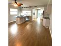 Open-concept living area featuring hardwood floors, and views into the updated kitchen at 6000 2Nd E St # 6, St Pete Beach, FL 33706