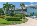 Building exterior showcasing manicured landscaping and patio seating at 6000 2Nd E St # 6, St Pete Beach, FL 33706