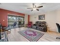 Living room with leather furniture and access to patio at 2525 Royal Pines Cir # 26H, Clearwater, FL 33763