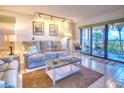 Living room with ocean view, comfy sofas, and tiled floors at 900 Gulf Blvd # 205, Indian Rocks Beach, FL 33785