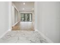 Bright entryway with marble flooring and view into the living area at 4817 Majestic Hills Loop, Brooksville, FL 34601
