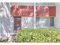 Exterior view of condo with red brick accents and well-manicured landscaping at 1877 Pine Cone Cir, Clearwater, FL 33760