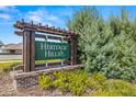 Heritage Hills community entrance sign with brick base and wood accents at 13862 Whiskey Daisy Dr, Dade City, FL 33525