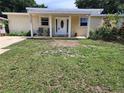 Inviting home featuring a covered front porch and a well-kept lawn at 1155 7Th N St, Safety Harbor, FL 34695