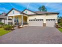 Beautiful home featuring a manicured lawn, covered porch, and a three-car garage at 4638 Southern Valley Loop, Brooksville, FL 34601