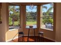 Cozy breakfast nook with scenic backyard view, hardwood floors, and stylish barstools at 7127 Forest Mere Dr, Riverview, FL 33578