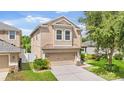 Traditional two-story home featuring an attached two car garage with mature landscaping at 7127 Forest Mere Dr, Riverview, FL 33578
