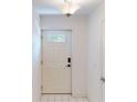 Front entry with white door and tile floor at 9550 Tara Cay Ct # 17, Seminole, FL 33776