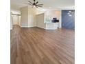 Spacious open-plan living room features sleek hardwood floors and stylish light fixtures throughout at 26933 Carmen Pl, Lutz, FL 33559