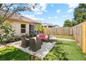 Inviting backyard with a patio seating area and a well-maintained lawn, perfect for outdoor entertaining at 2989 Brookfield Ln, Clearwater, FL 33761