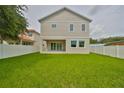 Large backyard with a two-story house and white fence at 3812 W Sevilla St, Tampa, FL 33629