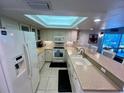Bright kitchen featuring white cabinets, granite countertops, and stainless steel appliances at 7530 Palm Island S Dr # 1413, Placida, FL 33946