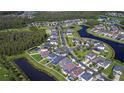 Aerial view of a neighborhood with houses and waterways at 19462 Paddock View Dr, Tampa, FL 33647