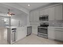 Modern kitchen with stainless steel appliances and island at 6950 Towering Spruce Dr, Riverview, FL 33578