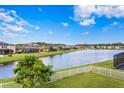 Lakefront property with white fence at 19433 Whispering Brook Dr, Tampa, FL 33647