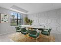 Bright dining room features a large window and stylish geometric wall detail at 19433 Whispering Brook Dr, Tampa, FL 33647