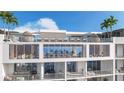 Condominium building with a rooftop fitness center, lounge chairs, outdoor seating, and beautiful blue sky views at 5701 Bowen Daniel Dr. # 504, Tampa, FL 33616