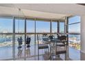 Dining area with walls of windows offers panoramic waterfront views, perfect for enjoying meals with a view at 800 S Gulfview Blvd # 903, Clearwater Beach, FL 33767