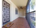 Screened balcony with tile flooring and ceiling fan at 2420 Winding Creek Blvd # 202, Clearwater, FL 33761