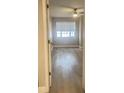 Bright bedroom with light wood flooring and a large window at 3002 W Cleveland St # E1, Tampa, FL 33609