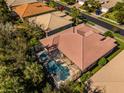 An aerial view showcasing a home with a private pool and screened enclosure at 4977 Sapphire Sound Dr, Wimauma, FL 33598