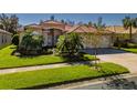 Two-story house with a three-car garage and well-manicured lawn at 4977 Sapphire Sound Dr, Wimauma, FL 33598