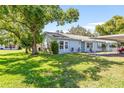 Charming house with lush green lawn and carport at 2222 Greenhaven Dr, Sun City Center, FL 33573