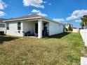 Covered patio in backyard with lawn and privacy fence at 11883 Brighton Knoll Loop, Riverview, FL 33579