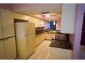 A full view of the kitchen with tile floor and vintage cabinets at 1601 43Rd S N St # 224, St Petersburg, FL 33713