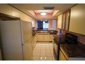 Retro kitchen design with light yellow cabinets and marble countertops at 1601 43Rd S N St # 224, St Petersburg, FL 33713