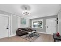 Bright living room with hardwood floors, brown couch and a coffee table at 1548 Ottawa Rd, Clearwater, FL 33756