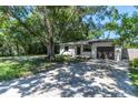 House with a large yard and driveway, freshly landscaped at 1548 Ottawa Rd, Clearwater, FL 33756