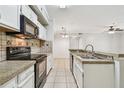 Bright kitchen with stainless steel sink and granite countertops at 5608 Pinnacle Heights Cir # 305, Tampa, FL 33624