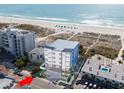Aerial view showcasing building's location and proximity to the beach at 10126 Gulf Blvd # Ph3, Treasure Island, FL 33706